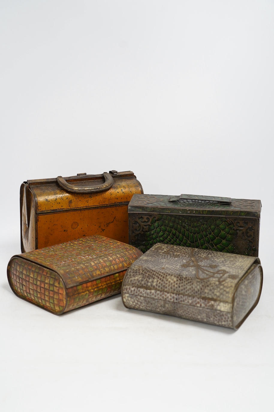 Four biscuit tins: an early 20th century Huntley & Palmers novelty biscuit tin, modelled as a Gladstone bag, 20cm wide, 16cm high, two other Huntley & Palmers tins and a Peek Frean novelty biscuit tin. Condition - fair